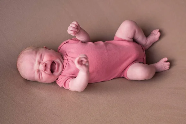 Little crying newborn baby on a brown blanket — Stock Photo, Image
