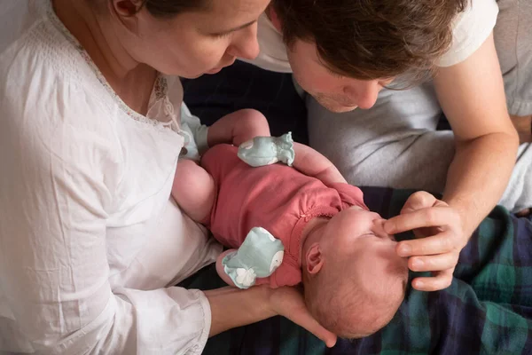 Happy parents holding their newborn baby girl — Stock Photo, Image