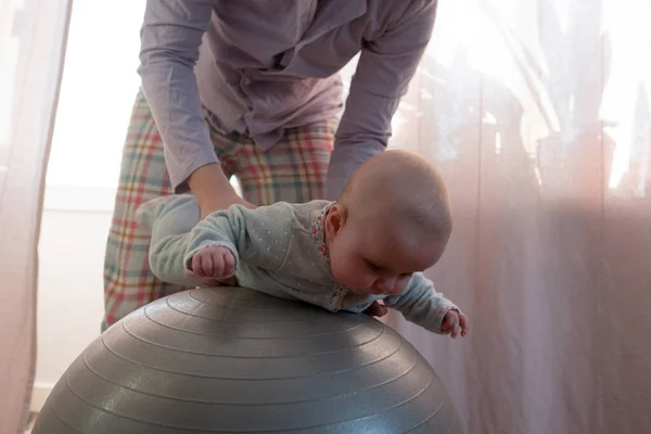 Mother and her baby girl having fun with gymnastic ball. — Stock Photo, Image