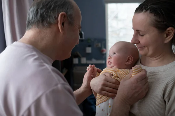 Grandfather looking on his granddaughter for first time — Stock Photo, Image