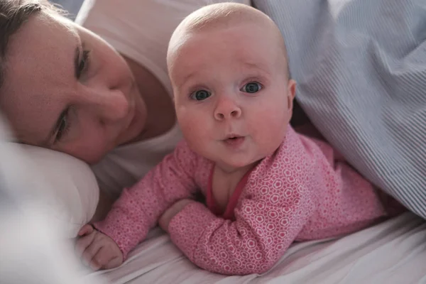 Happy loving caucasian mother spending time, playing with baby girl. — Stock Photo, Image