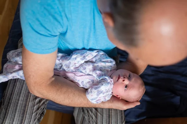 Grandfather holding a caucasian newborn baby girl — Foto Stock