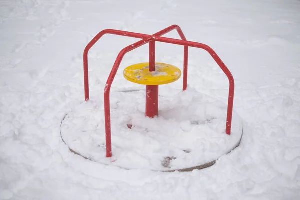 Swing seat covered with snow, winter season — Zdjęcie stockowe