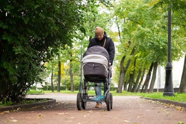 Happy young father with pram during the walk in nature — Stock Photo, Image