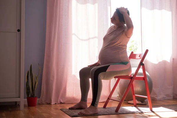 Mulher grávida em esteira de fitness, treinamento em casa — Fotografia de Stock