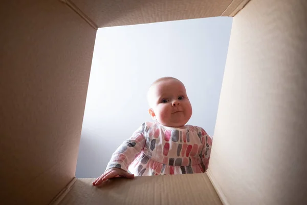 Happy baby into parcel cardboard box and smiling. — Stock Photo, Image