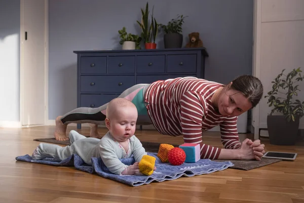 Mother with baby make yoga at home to be strong and healthy — Stock Photo, Image