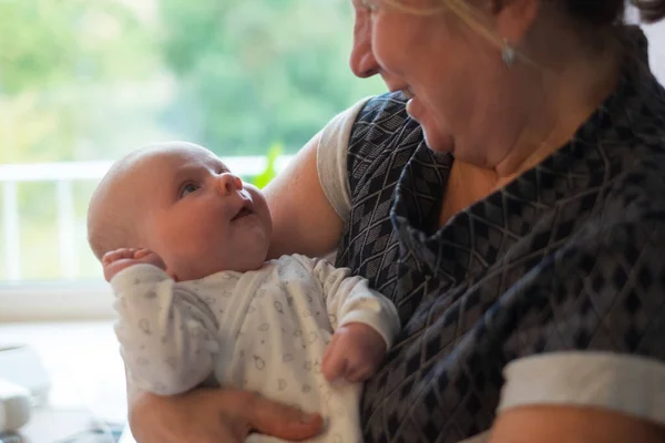 갓난아기를 안고 있는 연로 한 할머니 — 스톡 사진