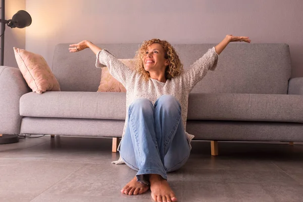 Cheerful Young Woman Sitting Floor Arms Raised Home — Stock Photo, Image