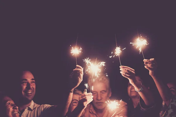 Family Celebrating Holding Burning Sparkles Arms Raised Group Multi Generation — Fotografia de Stock