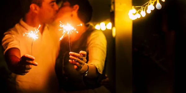 Couple Holding Burning Sparkle Loving Kissing Each Other Celebrating Birthday — Zdjęcie stockowe