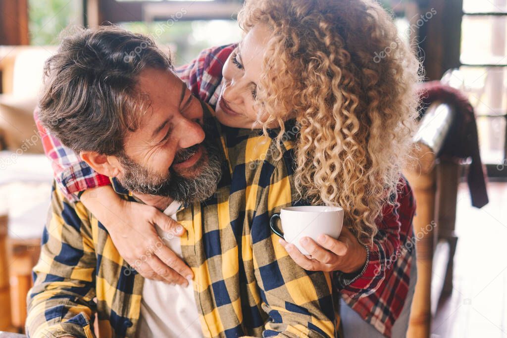 Man and woman at home smile and enjoy love relationship and friendship together.