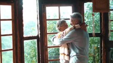 Elderly people happy lifesryle activity with senior man and woman dancing excited at home for love and relationship