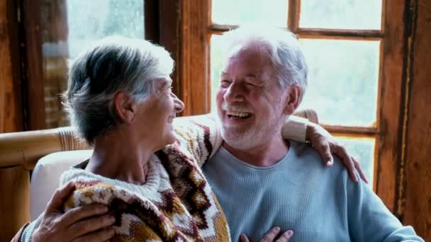 Happy Enjoyed Senior Caucasian Couple Smile Hug Each Other Sitting — стокове відео