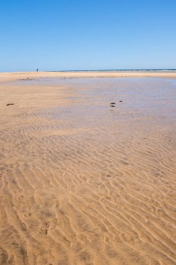 Sand and beach landscape with transparent clean tropical ocean water. Blue sky in background. Concept of summer travel holiday vacation inscenic place