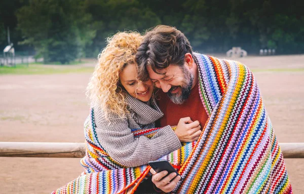 Adult Caucasian Couple Enjoy Love Relationship Using Together Smart Phone — Stock Photo, Image