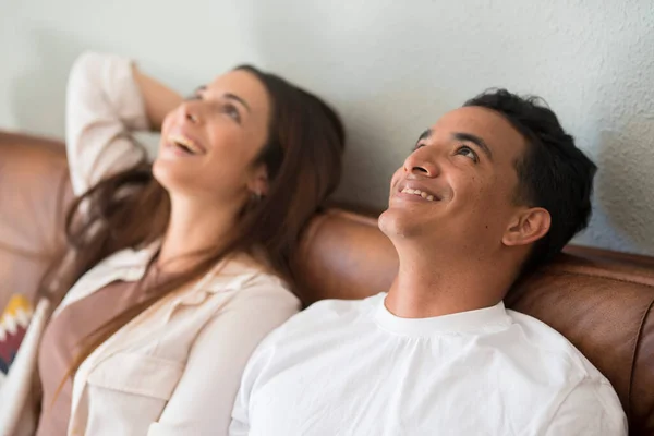 Young Couple Dreaming Together Home Sitting Sofa Looking Smile People - Stock-foto