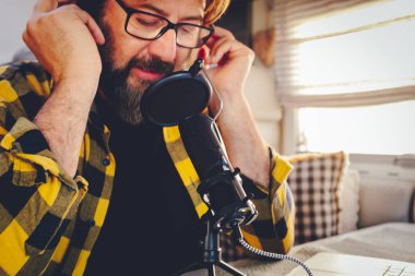 Close up of man using or singing in a microphone. Concept of podcast production and online free job and lifestyle. Modern worker creating content for web channel. Online job business internet