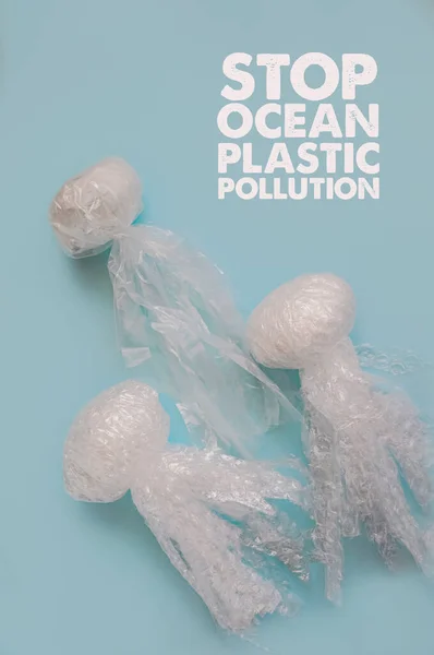 Sea and ocean life from waste. Jellyfishes out of plastic waste on blue background. Pollution of the planet. Concept of saving the environment, oceans, seas and rivers