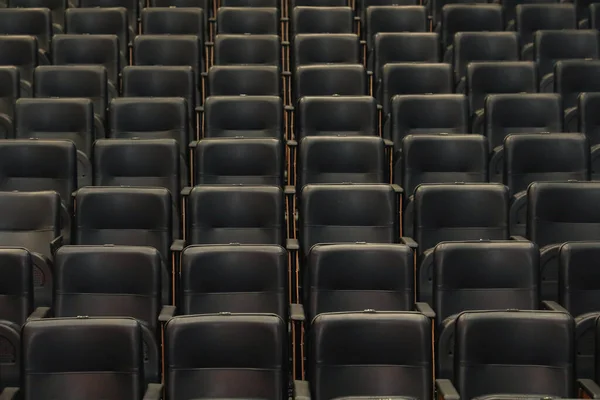 黒い椅子と木製の側面に重点を置いた劇場の講堂 すべて同じ与える継続性とライン — ストック写真
