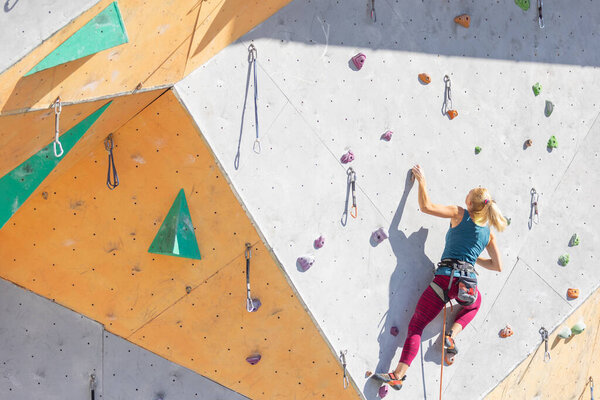 a girl goes through a difficult route in rock climbing training. sport climbin