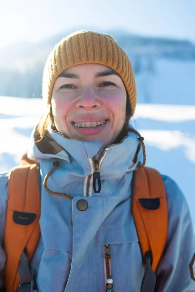 笑着的女人 牙齿上戴着牙套 在冬天的群山和白雪覆盖的树木的背景下描绘着一个女孩 — 图库照片