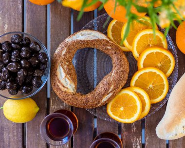 Türk kahvaltısı, Türk çayı, portakal ve zeytin, susamlı simit ve ahşap masa üzerinde saksı bitkisi
