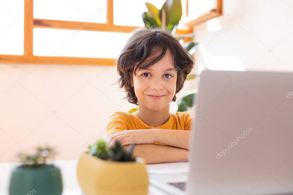 child boy is using a laptop and study online with video call teacher at home, homeschooling, distant learning, online education, child on online lesson, distance education