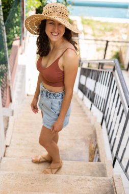 portrait of a young girl in a summer hat while relaxing in a country house.