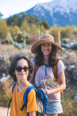 mother and son on a hike. the child travels with his mother along a mountain path and forests. summer vacation.