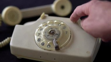 Male hand presses the lever of the old phone