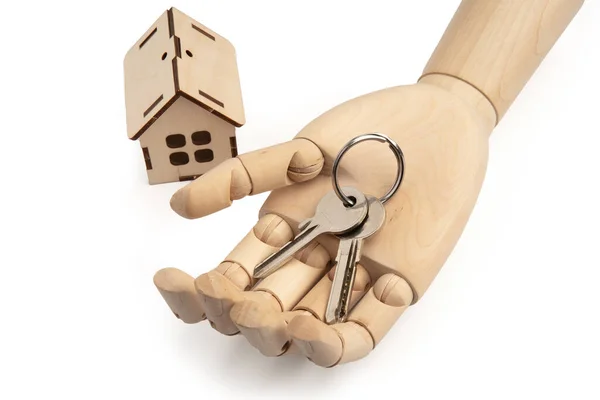 Houten poppen hand met sleutels op de palm met speelgoed houten huis geïsoleerd op wit — Stockfoto