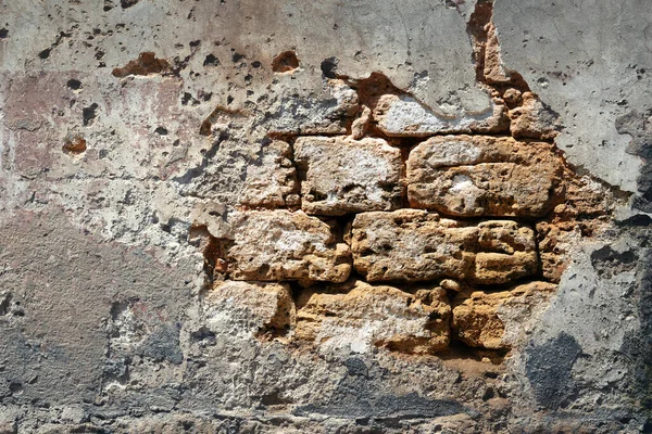 Background with Ancient brick wall wall with fallen off plaster