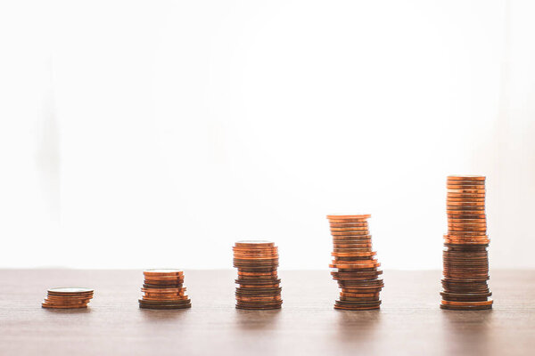 Several stacks of 1, 2 and 5 cent coins symbolizing the bars of an upward trending graph.