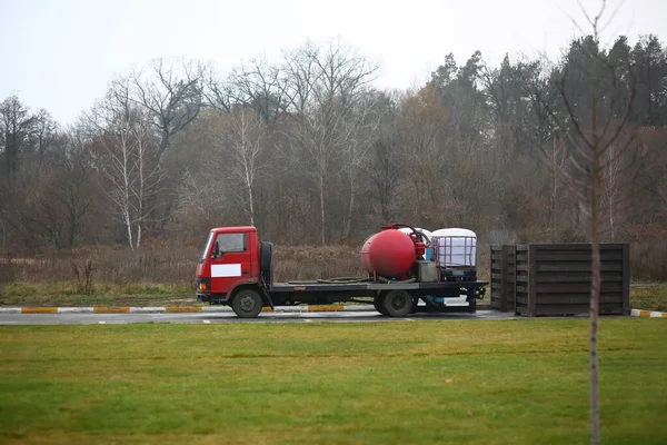 Toilet service truck cleaning portrable biotoilet tank in the public park