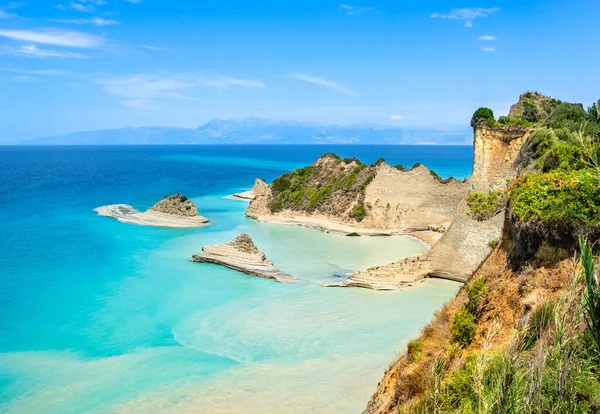 Cape Drastis cliffs near Sidari and Peroulades on Corfu island in Greece. Famous rock formations with small beach and rugged coastline. Popular Greek destination for summer vacation. — Stock Photo, Image