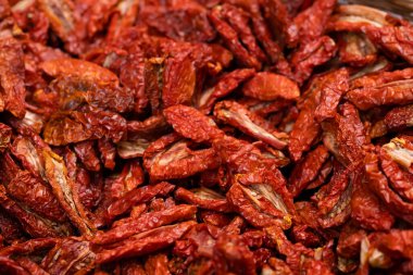 Pile of sun dried tomatoes typical for Italy. Food background. Shallow depth of field clipart