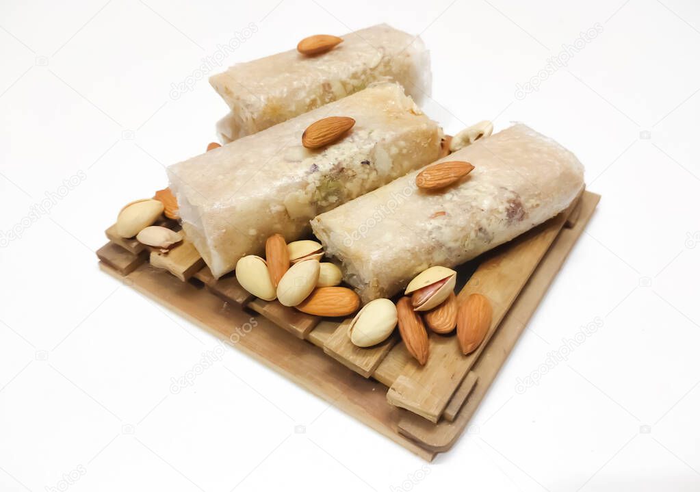 Closeup of South Indian traditional dish or Sweet pootharekelu made with rice floor, ghee and dry fruits. Isolated in a White background with selective focus and copy space for inscription