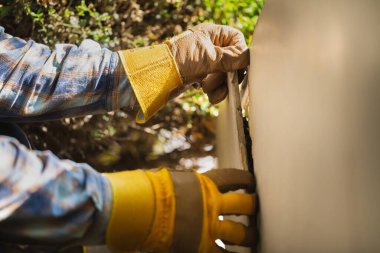 Eldivenli bir işçi merdivenlerin seramik fayanslarını söker.