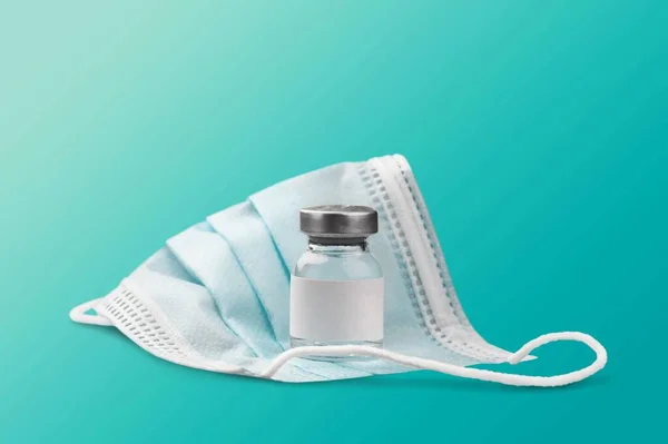 Schutzmaske Und Impfflasche Auf Blauem Hintergrund — Stockfoto