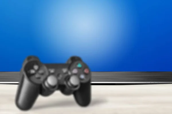 Schwarzer Klassischer Playstation Spielcontroller Auf Dem Schreibtisch — Stockfoto