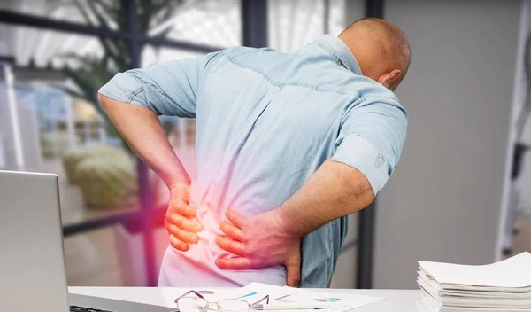 young businessman with back pain  on background