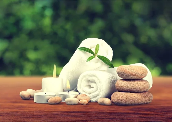Spa Composition Towels Candles Stones Wooden Table — Stock Photo, Image