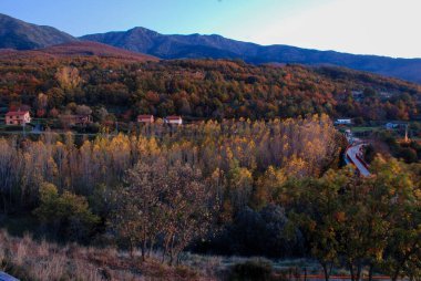 View Monte de Hervas via verde via de la Plata autumn colors ocher yellow green sunset clipart