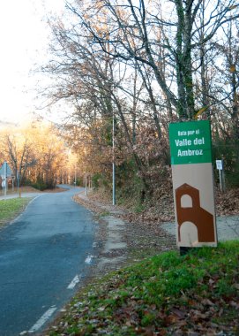 Roadside signpost for Route through El Valle Del Ambroz in autumn in vertical 2