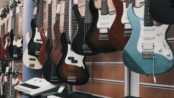 Many New Different Multicolored Electric Guitars are Sold in the Store — стоковое видео