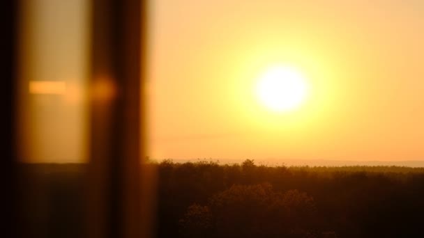 Sonnenuntergang am Himmel über dem Horizont, Blick hinter die Silhouette des Fensters — Stockvideo