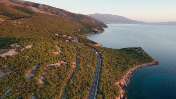 Aerial View Landscape Rocky Coast of Croatia with Curvy Mountain Road at Sunset — Stok video