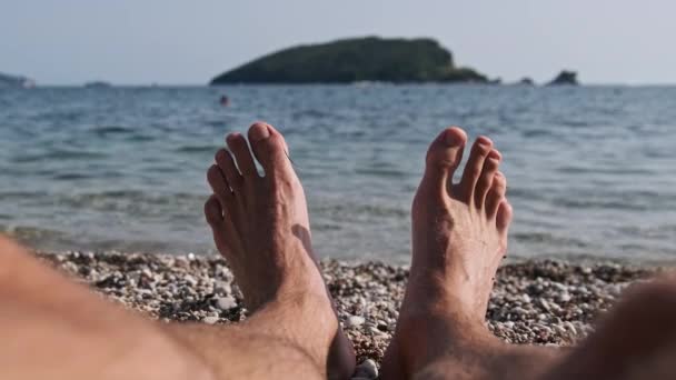 POV Mladý muž bosý nohy na oblázkové pláži u mořské krajiny — Stock video
