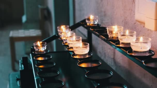 Burning Candles Inside Church Interior, Prayer Candles Lit in Row, Spirituality — Stock Video